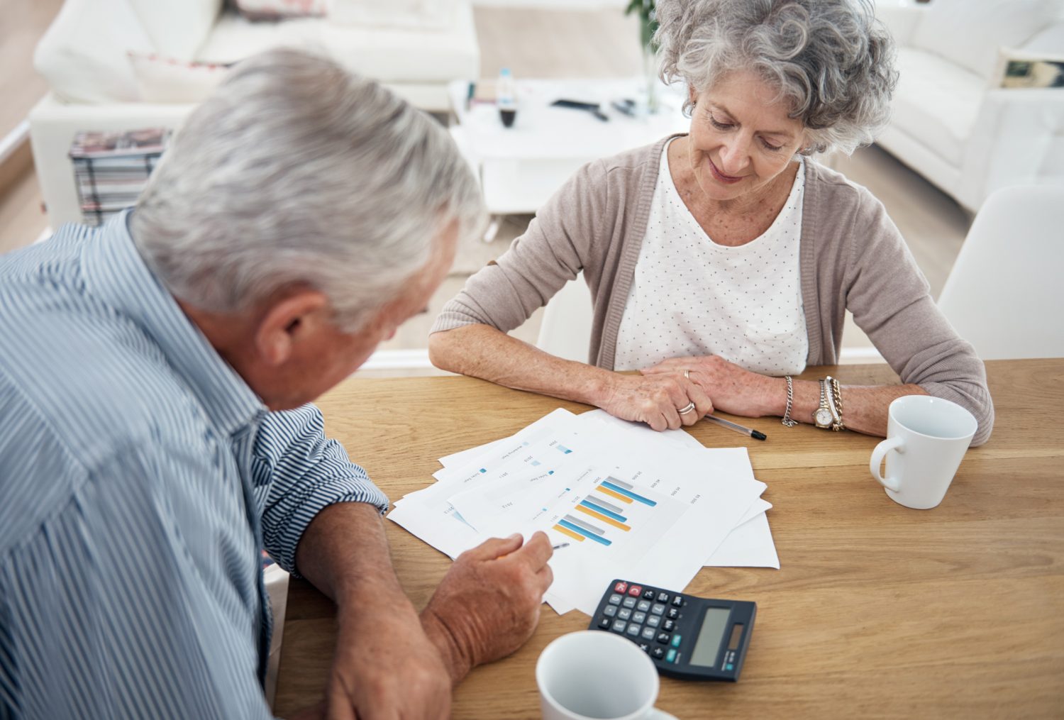 Cropped shot of a senior couple reviewing their financial